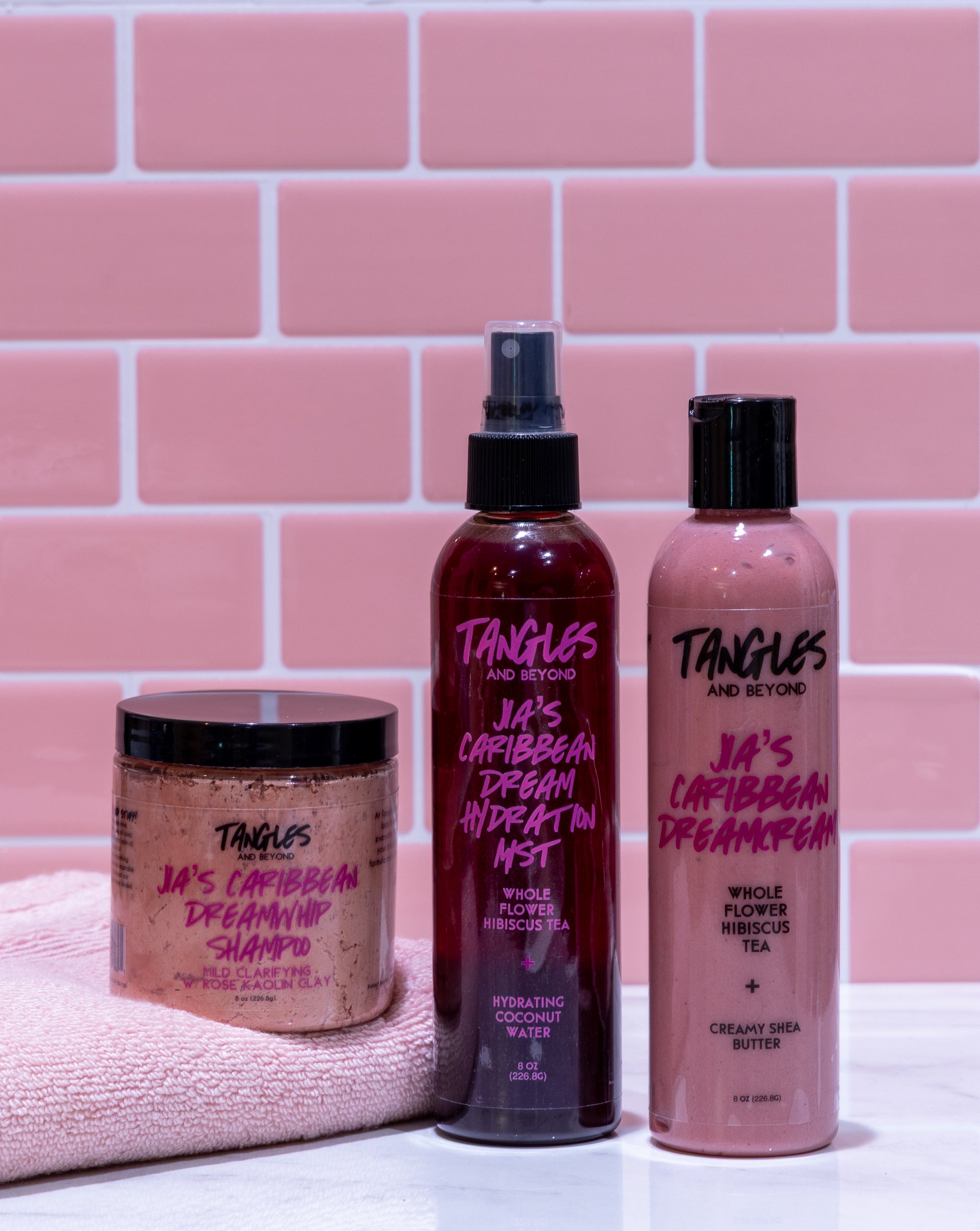 Jia's Caribbean Dream Collection with pink towel on pink tiled background.