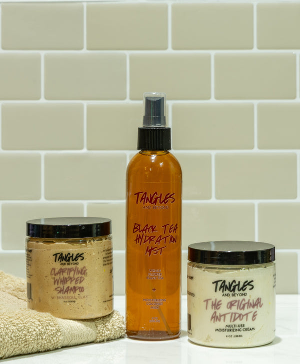 Rhassoul, Black Tea, and Antidote Collection on beige background with beige towel.