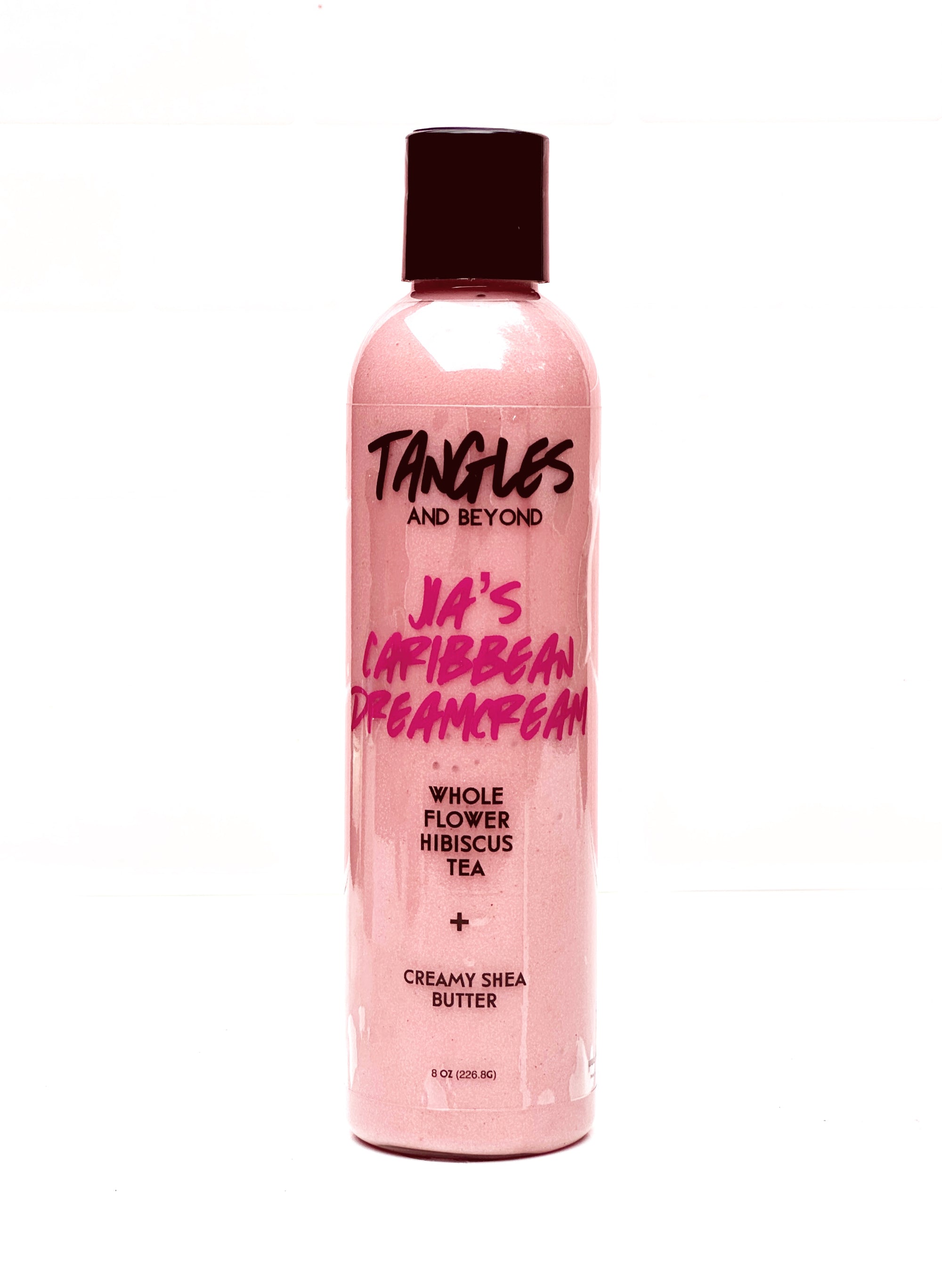 Pink bottle of Dreamcream with black lid labeled 'Tangles and Beyond' on a white background