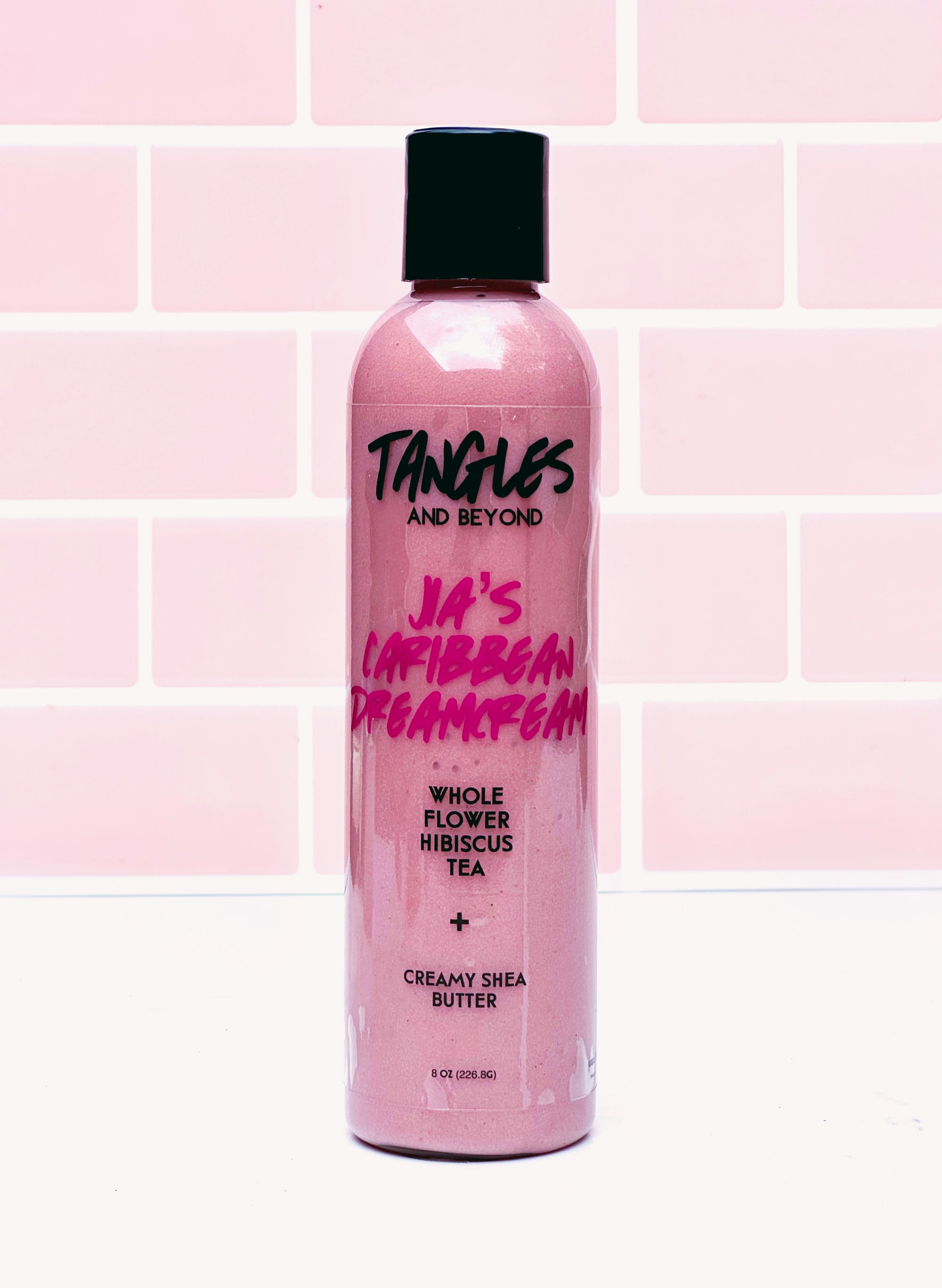 Pink bottle with black cap on a pink tiled background