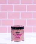 Jar of shampoo with visible branding against a pink tiled wall