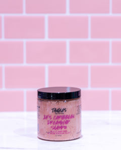 Jar of shampoo with visible branding against a pink tiled wall