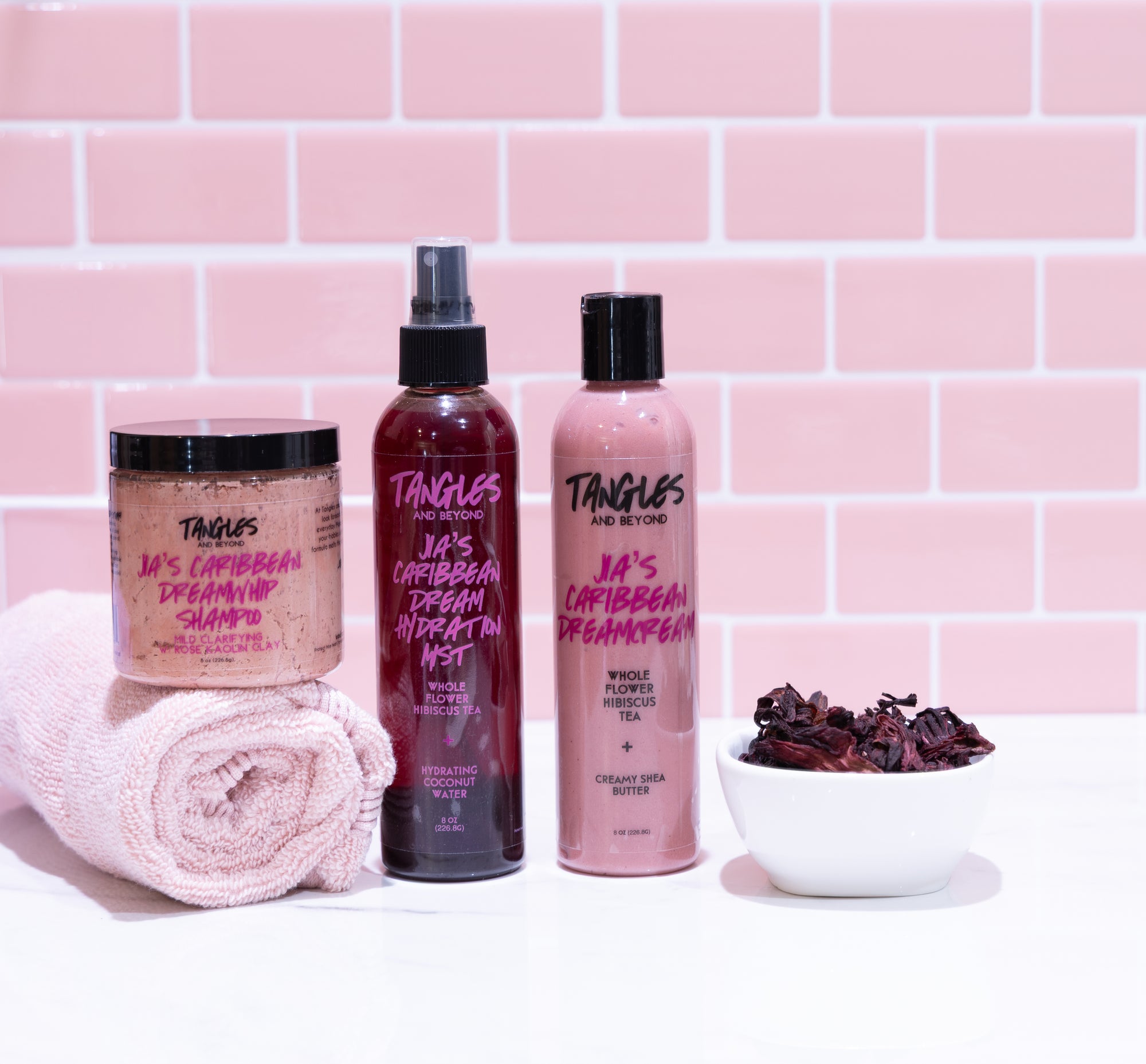 Tangles hair care products with a pink tiled background
