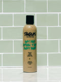 Bottle of 'Tangles and Beyond' product on a tiled wall background