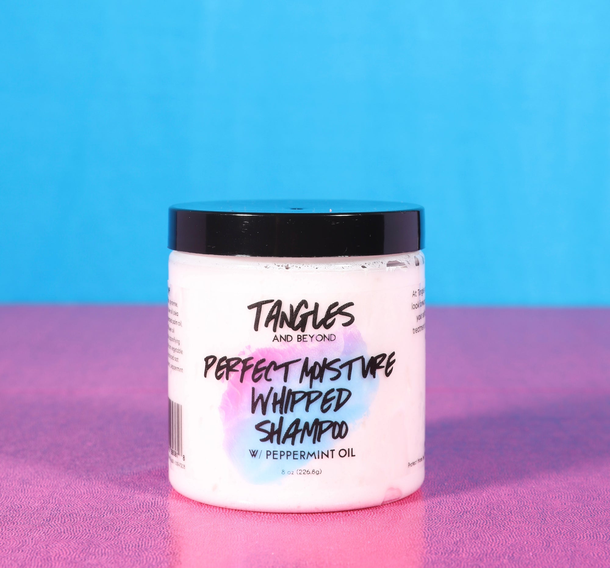 Perfect Moisture Whipped Shampoo by Tangles and Beyond on pink and blue background 
