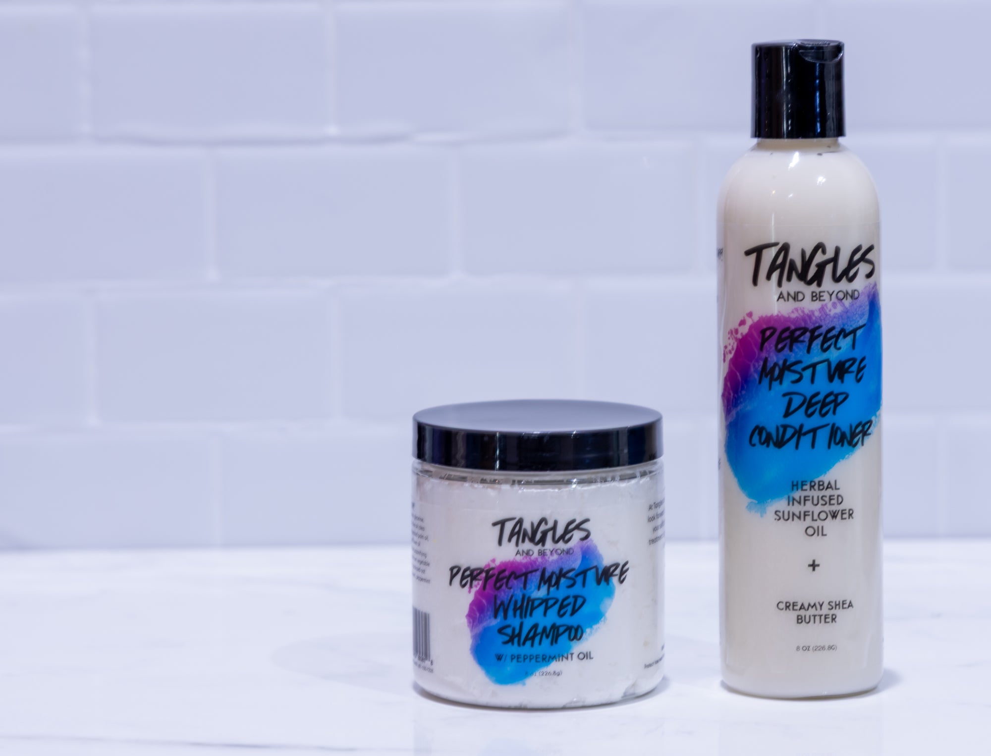 Two hair care products with colorful labels on a white background