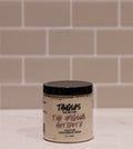 Jar of 'Tangles and Beyond The Original Antidote' cream on a tiled bathroom counter.